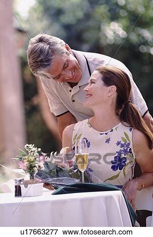 Happy couple having meal on patio View Large Photo Image Stock Photo - Happy couple having meal on patio. Fotosearch