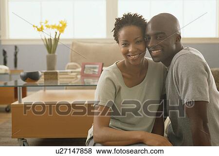 Happy couple sitting together on the floor of their home View Large Photo Image Stock Photo - Happy couple sitting together on the floor of their home. Fotosearch