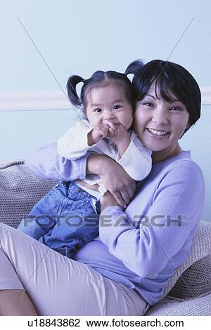 Happy mother holding her infant daughter View Large Photo Image Stock Image - Happy mother holding her infant daughter. Fotosearch