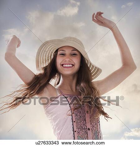 Happy woman holding her arms in the air View Large Photo Image Stock Image - Happy woman holding her arms in the air. Fotosearch