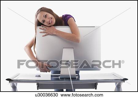 Happy woman hugging a computer monitor View Large Photo Image Stock Image - Happy woman hugging a computer monitor. Fotosearch