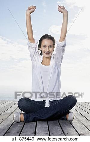 Stock Photo - Happy woman sitting on porch. Fotosearch
