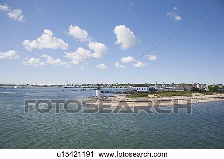 Stock Image - Harbor and Brant Point lighthouse in Nantucket. Fotosearch