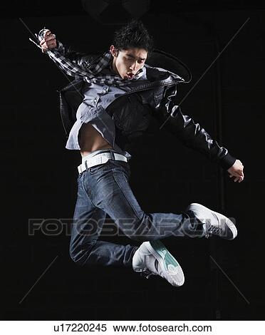 Stock Photography - Hip hop dancer jumping in the air. Fotosearch