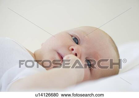 Stock Image - Infant lying on his back. Fotosearch