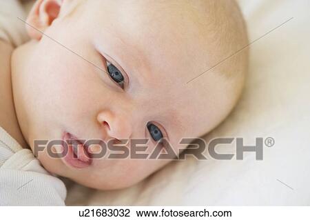 Stock Image - Infant sticking his tongue out. Fotosearch