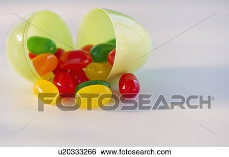 Jelly beans in a plastic Easter egg View Large Photo Image Stock Photograph - Jelly beans in a plastic Easter egg. Fotosearch
