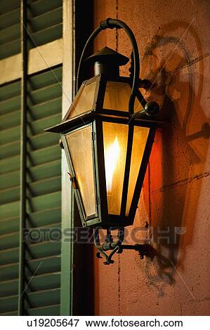 Stock Photo - Lantern on wall of building in French Quarter of New Orleans. Fotosearch