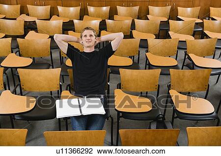 Stock Image - Last student left in college lecture hall. Fotosearch