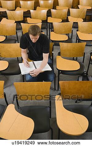 Last student left in college lecture hall View Large Photo Image Stock Photo - Last student left in college lecture hall. Fotosearch