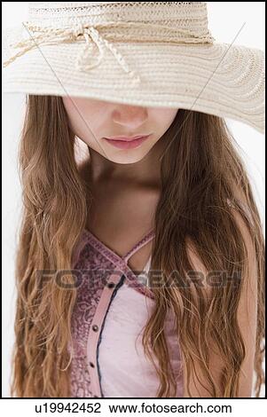 Long haired woman wearing a straw hat that covers her eyes View Large Photo Image Stock Image - Long haired woman wearing a straw hat that covers her eyes. Fotosearch