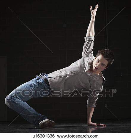 Stock Photograph - Male dancer balancing on one arm. Fotosearch