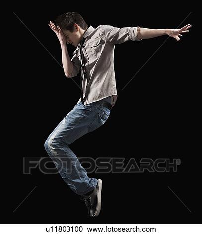 Male dancer jumping in the air View Large Photo Image Stock Image - Male dancer jumping in the air. Fotosearch