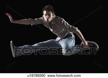Male dancer jumping in the air View Large Photo Image Stock Image - Male dancer jumping in the air. Fotosearch