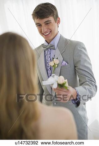 Man giving corsage to woman View Large Photo Image Stock Image - Man giving corsage to woman. Fotosearch