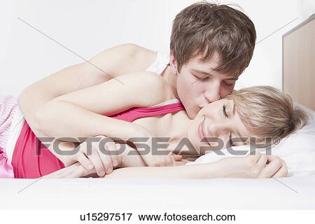 Man kissing woman in bed View Large Photo Image Stock Photo - Man kissing woman in bed. Fotosearch
