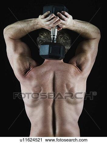 Stock Image - Man lifting free weight behind his head. Fotosearch