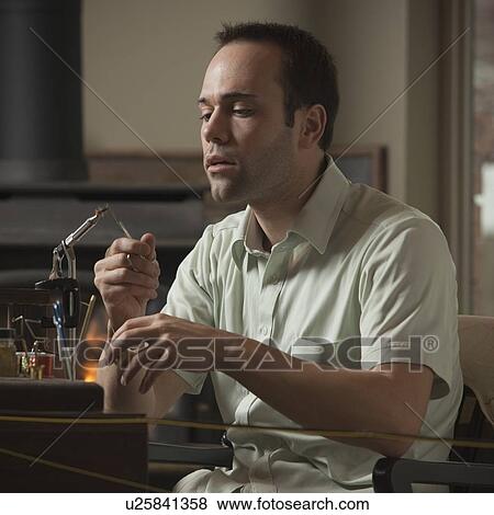 Man repairing fly fishing hook View Large Photo Image Stock Photo - Man repairing fly fishing hook. Fotosearch