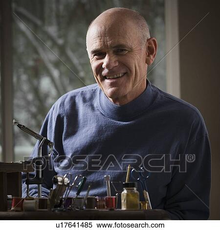 Man sitting behind fishing gear repair equipment View Large Photo Image Stock Photography - Man sitting behind fishing gear repair equipment. Fotosearch