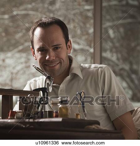 Man sitting behind fishing repair equipment View Large Photo Image Stock Photograph - Man sitting behind fishing repair equipment. Fotosearch