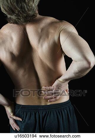 Picture - Man with back pain. Fotosearch