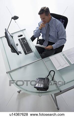 Man working at desk View Large Photo Image Stock Photo - Man working at desk. Fotosearch
