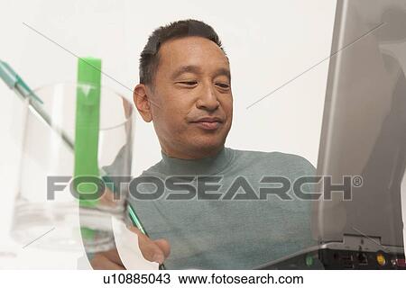 Man working on laptop View Large Photo Image Stock Image - Man working on laptop. Fotosearch
