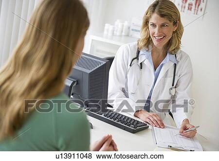 Medical consultation in exam room View Large Photo Image Stock Photo - Medical consultation in exam room. Fotosearch