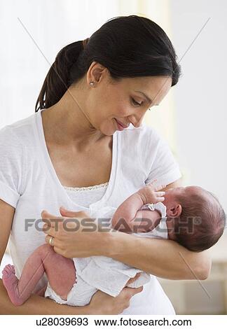 Mother holding her baby View Large Photo Image Stock Image - Mother holding her baby. Fotosearch