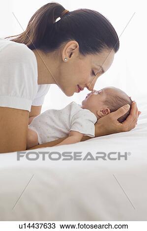 Mother holding her sleeping baby View Large Photo Image Stock Image - Mother holding her sleeping baby. Fotosearch