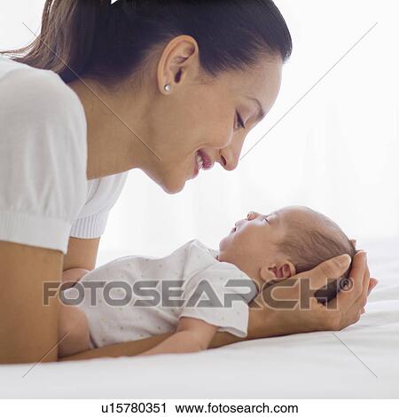 Mother holding her sleeping baby View Large Photo Image Stock Image - Mother holding her sleeping baby. Fotosearch