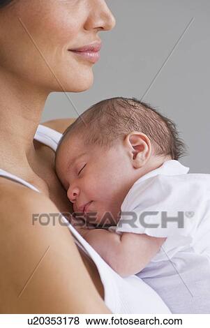 Mother holding sleeping baby View Large Photo Image Stock Photo - Mother holding sleeping baby. Fotosearch