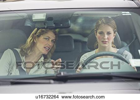 Mother teaching her daughter how to drive View Large Photo Image Picture - Mother teaching her daughter how to drive. Fotosearch