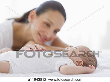 Mother watching her baby sleep View Large Photo Image Stock Image - Mother watching her baby sleep. Fotosearch