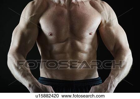 Stock Image - Muscular man flexing his muscles. Fotosearch