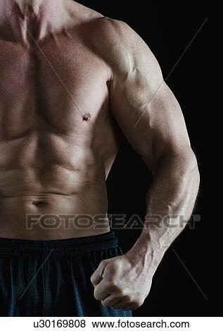 Muscular man flexing his muscles View Large Photo Image Stock Photo - Muscular man flexing his muscles. Fotosearch