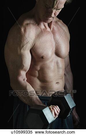 Muscular man lifting free weight View Large Photo Image Stock Photography - Muscular man lifting free weight. Fotosearch