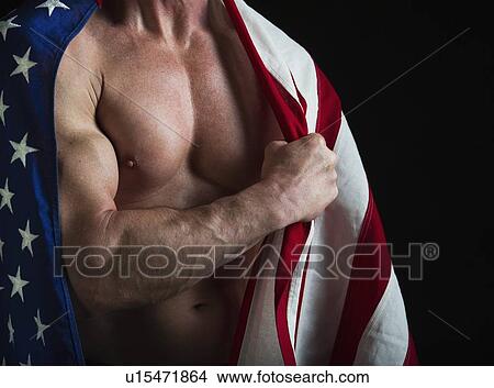 Muscular man wearing American flag as a cape View Large Photo Image Picture - Muscular man wearing American flag as a cape. Fotosearch