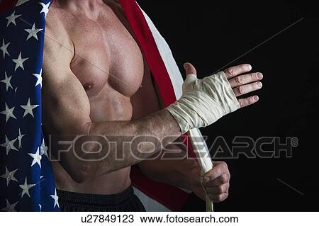 Muscular man wearing American flag as a cape View Large Photo Image Stock Image - Muscular man wearing American flag as a cape. Fotosearch