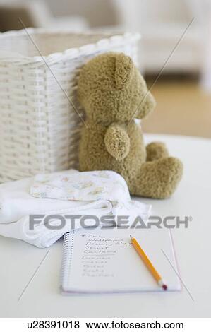Notebook beside baby items View Large Photo Image Stock Photo - Notebook beside baby items. Fotosearch