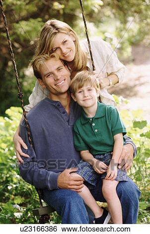 Parents and their young son posing by swing View Large Photo Image Stock Photograph - Parents and their young son posing by swing. Fotosearch