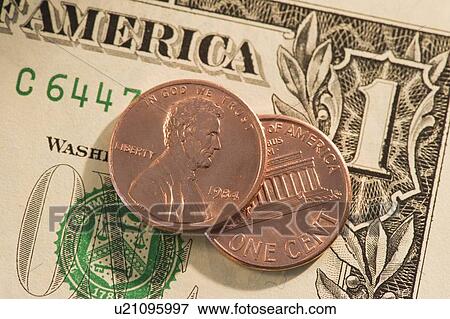 Pennies on top of American dollar bill View Large Photo Image Stock Photo - Pennies on top of American dollar bill. Fotosearch
