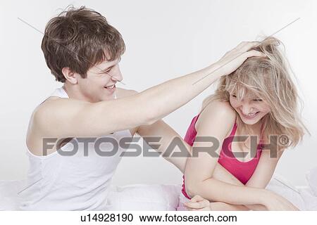 Stock Image - Playful couple in bed. Fotosearch