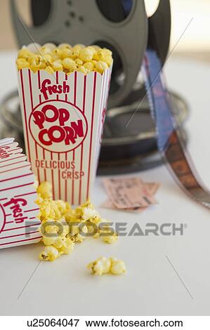 Popcorn and movie reel View Large Photo Image Stock Photo - Popcorn and movie reel. Fotosearch