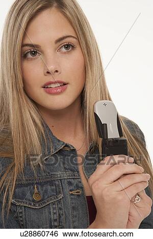 Pretty blond woman holding cell phone View Large Photo Image Stock Photograph - Pretty blond woman holding cell phone. Fotosearch
