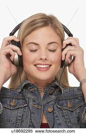 Pretty blond woman wearing headphones View Large Photo Image Stock Photography - Pretty blond woman wearing headphones. Fotosearch