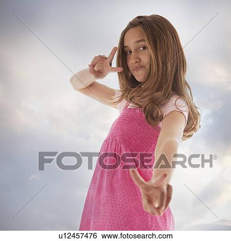 Stock Photograph - Pretty teenage girl giving peace sign. Fotosearch