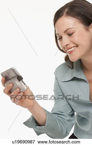 Pretty woman looking at PDA View Large Photo Image Stock Photo - Pretty woman looking at PDA. Fotosearch