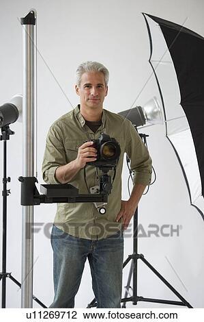 Professional photographer in his studio View Large Photo Image Stock Image - Professional photographer in his studio. Fotosearch