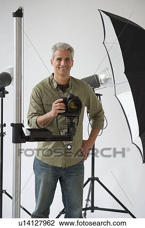 Stock Image - Professional photographer in his studio. Fotosearch